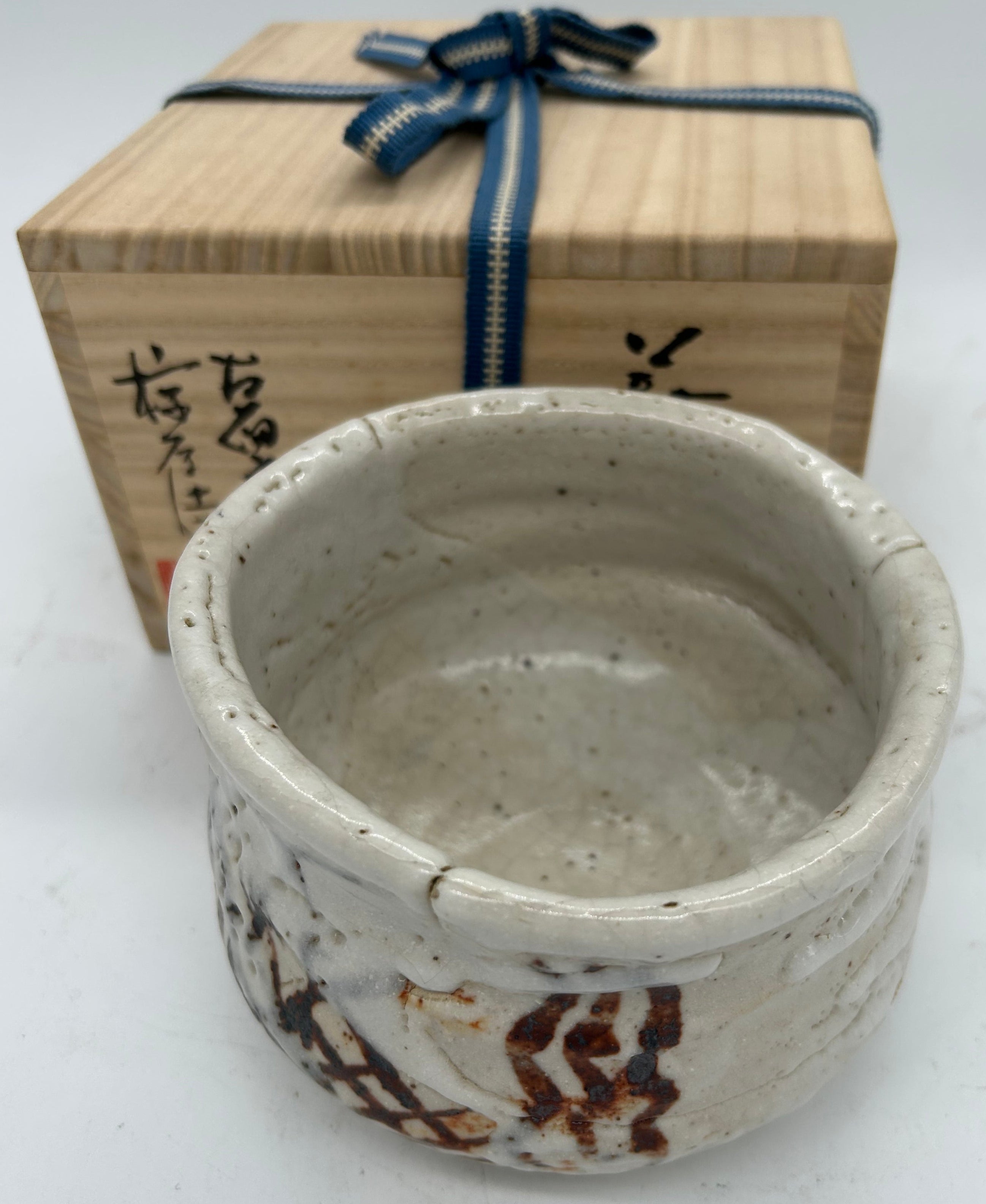 Ceramic bowl with wooden box on a white background