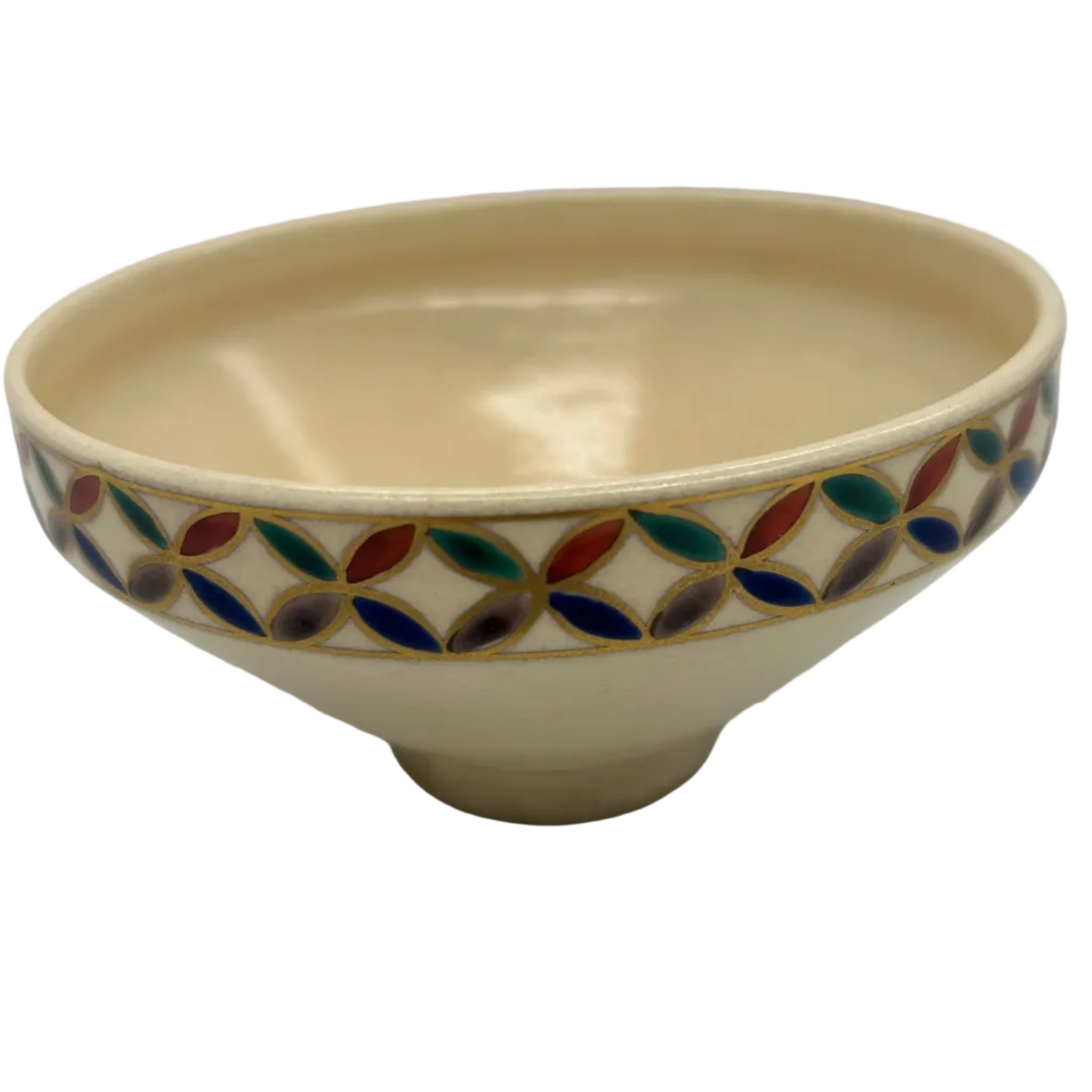A cream-colored ceramic bowl with a colorful enamel-style leaf pattern around the rim, set against a plain light gray background.