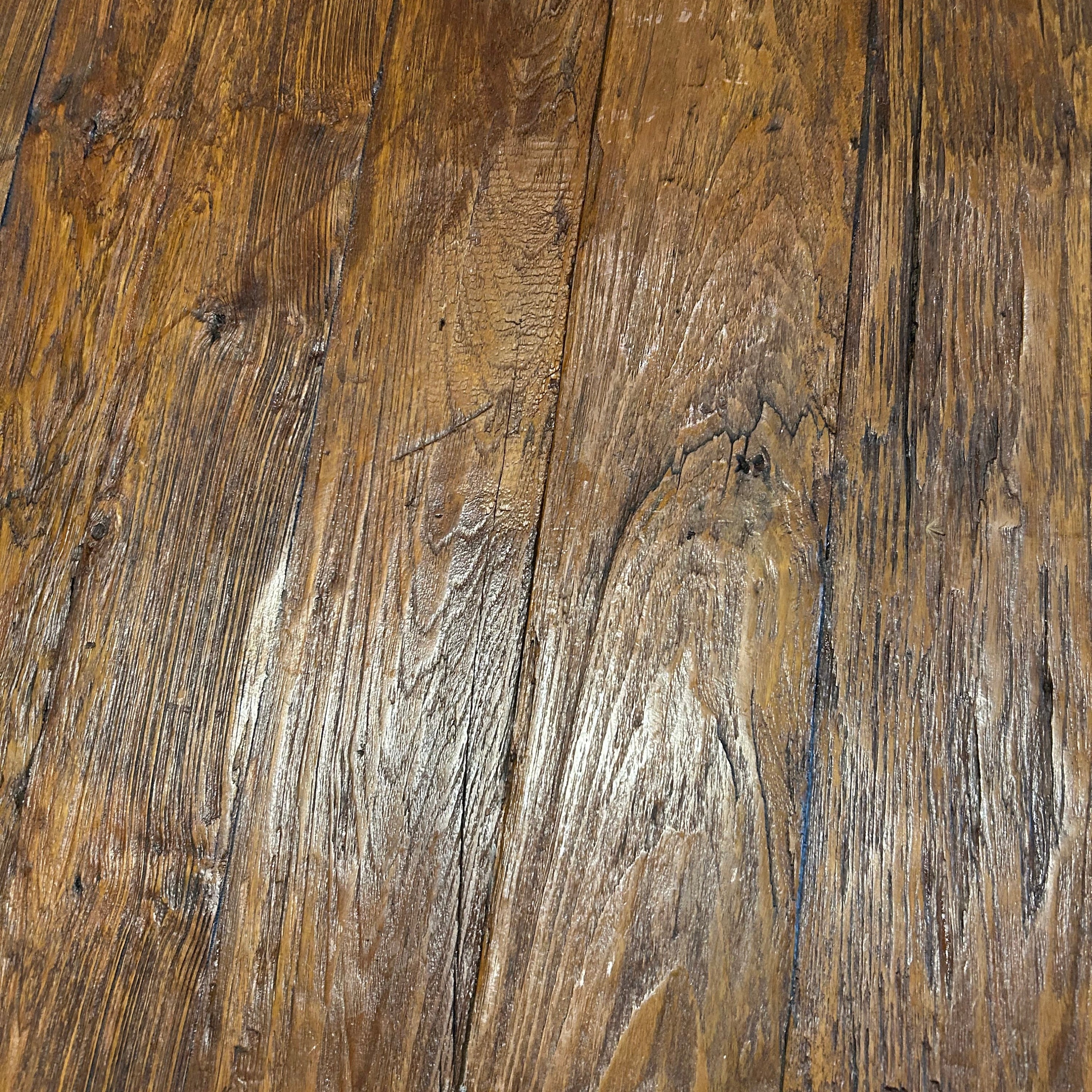 A contemporary square coffee table with natural textured grain, made of recycled timber.