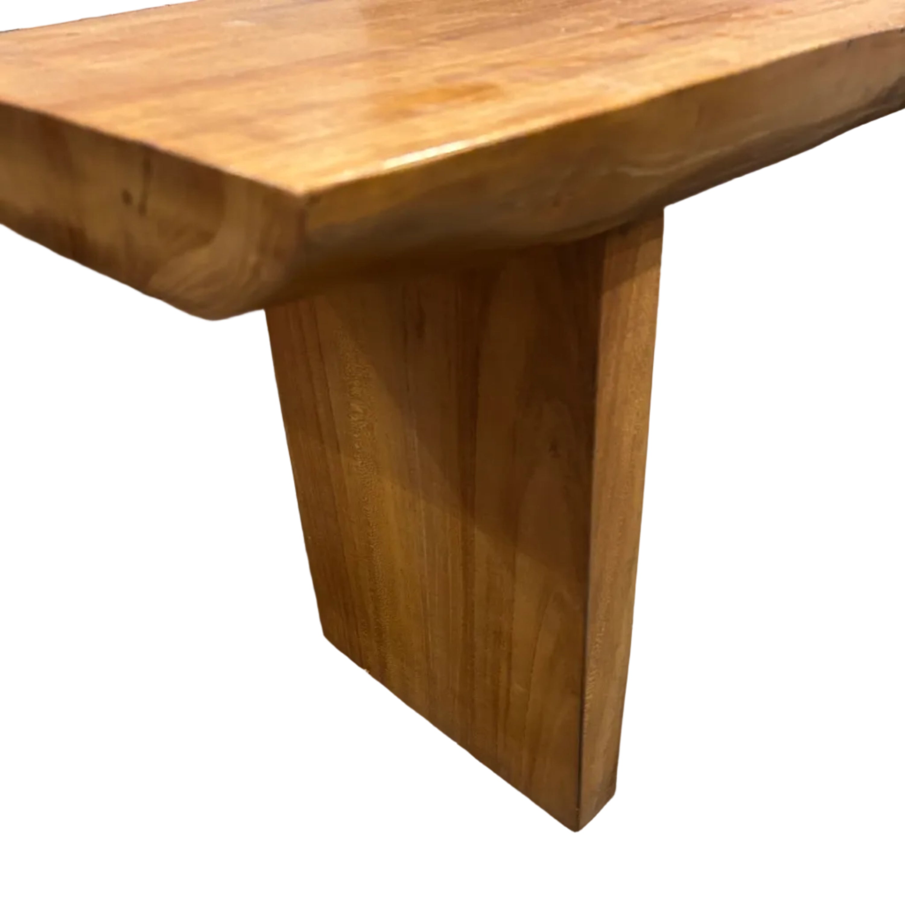 A contemporary long coffee table with the natural shape of a log and honey coloured grain, made of recycled timber.