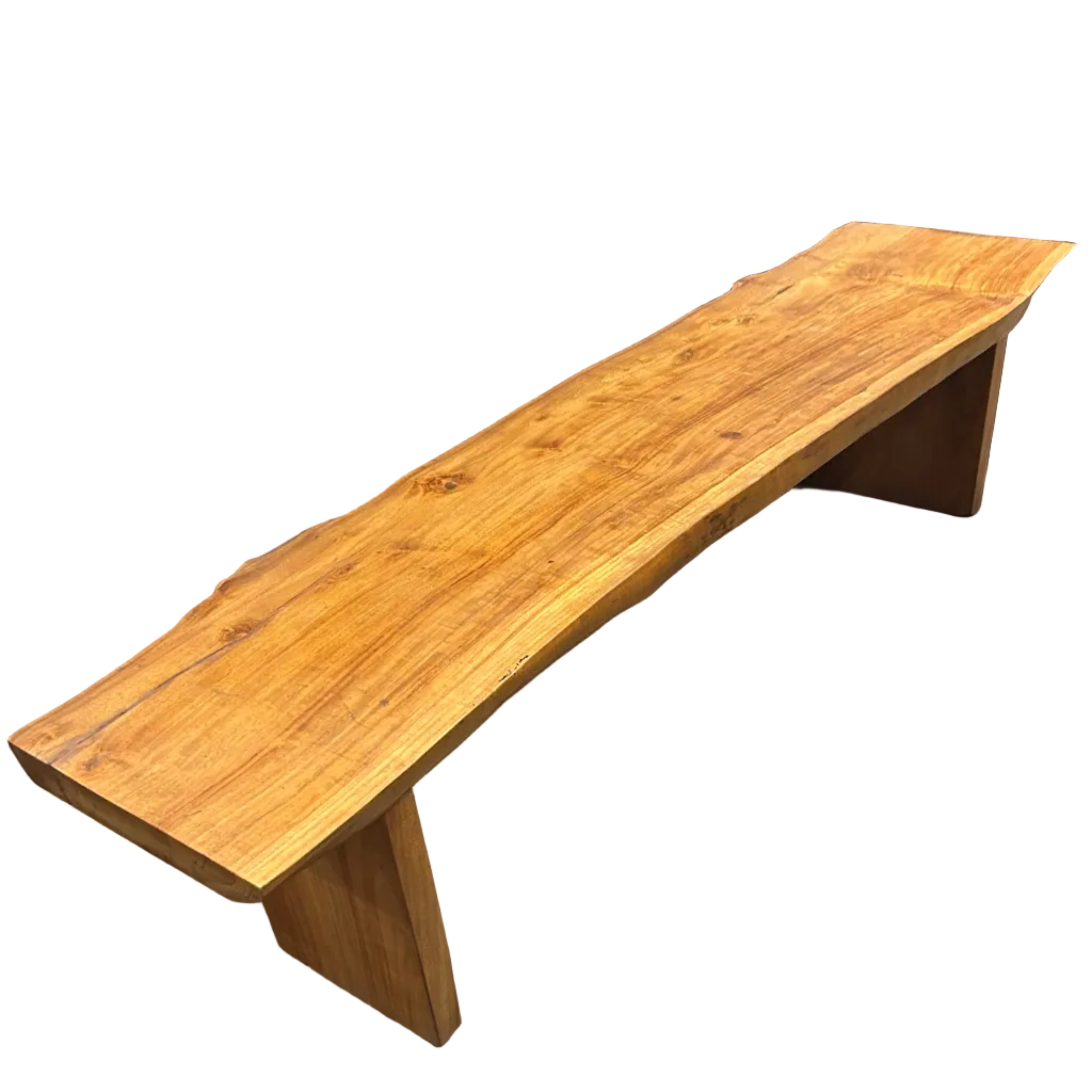 A contemporary long coffee table with the natural shape of a log and honey coloured grain, made of recycled timber.