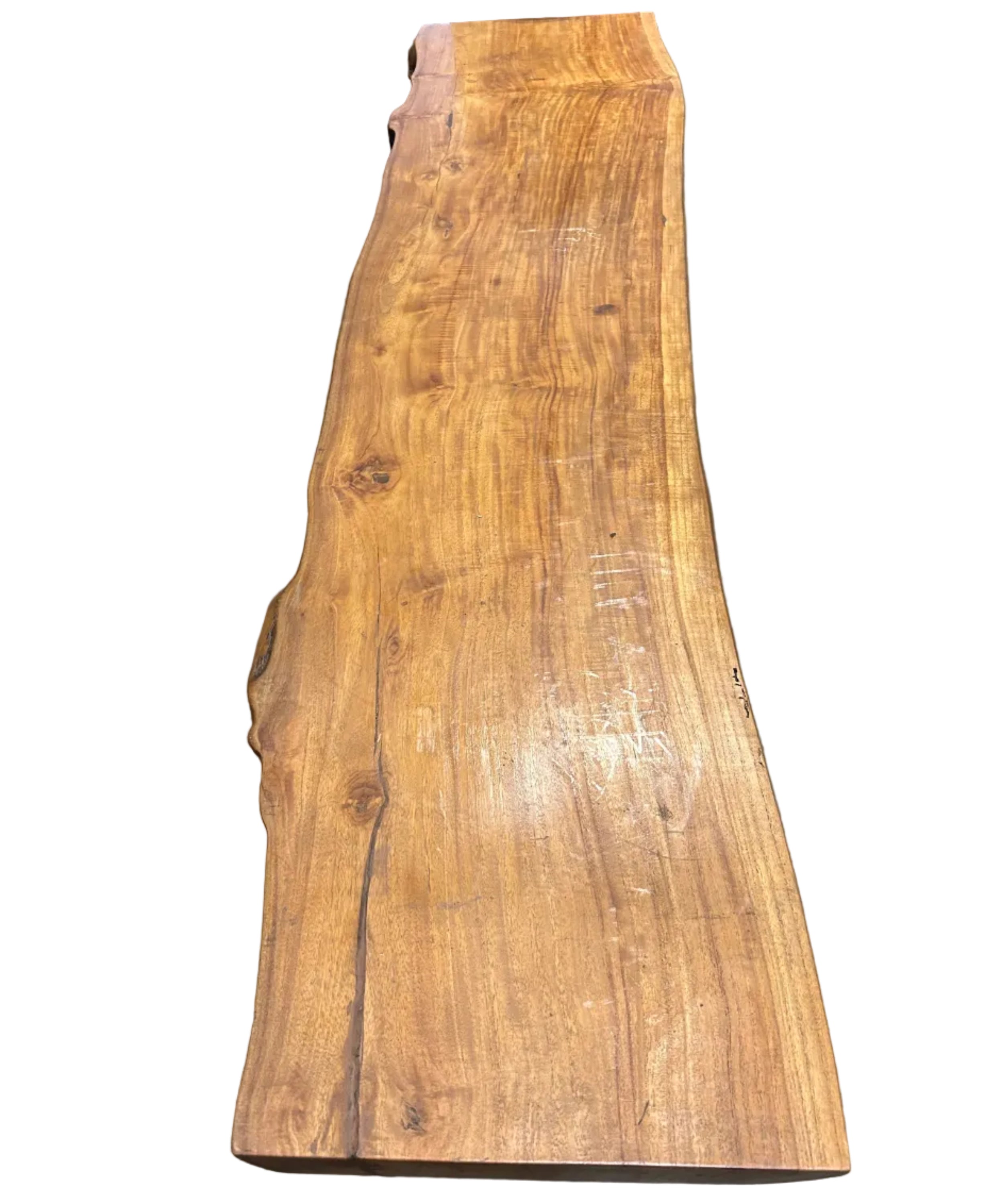 A contemporary long coffee table with the natural shape of a log and honey coloured grain, made of recycled timber.