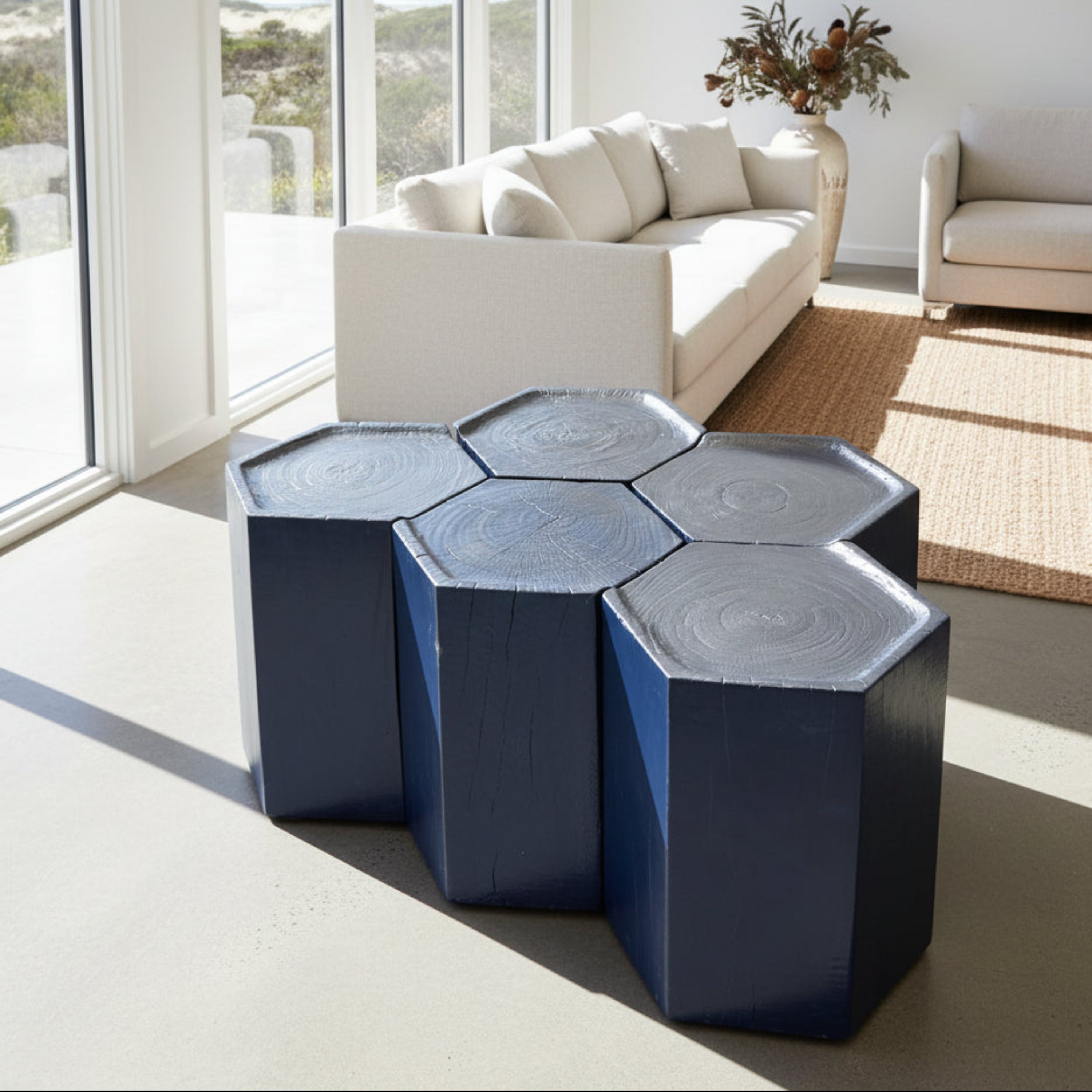 Set of five hexagonal stools in solid ebonized timber. Modular design slots together to form a larger table. Each 35 × 35 × 47 cm.