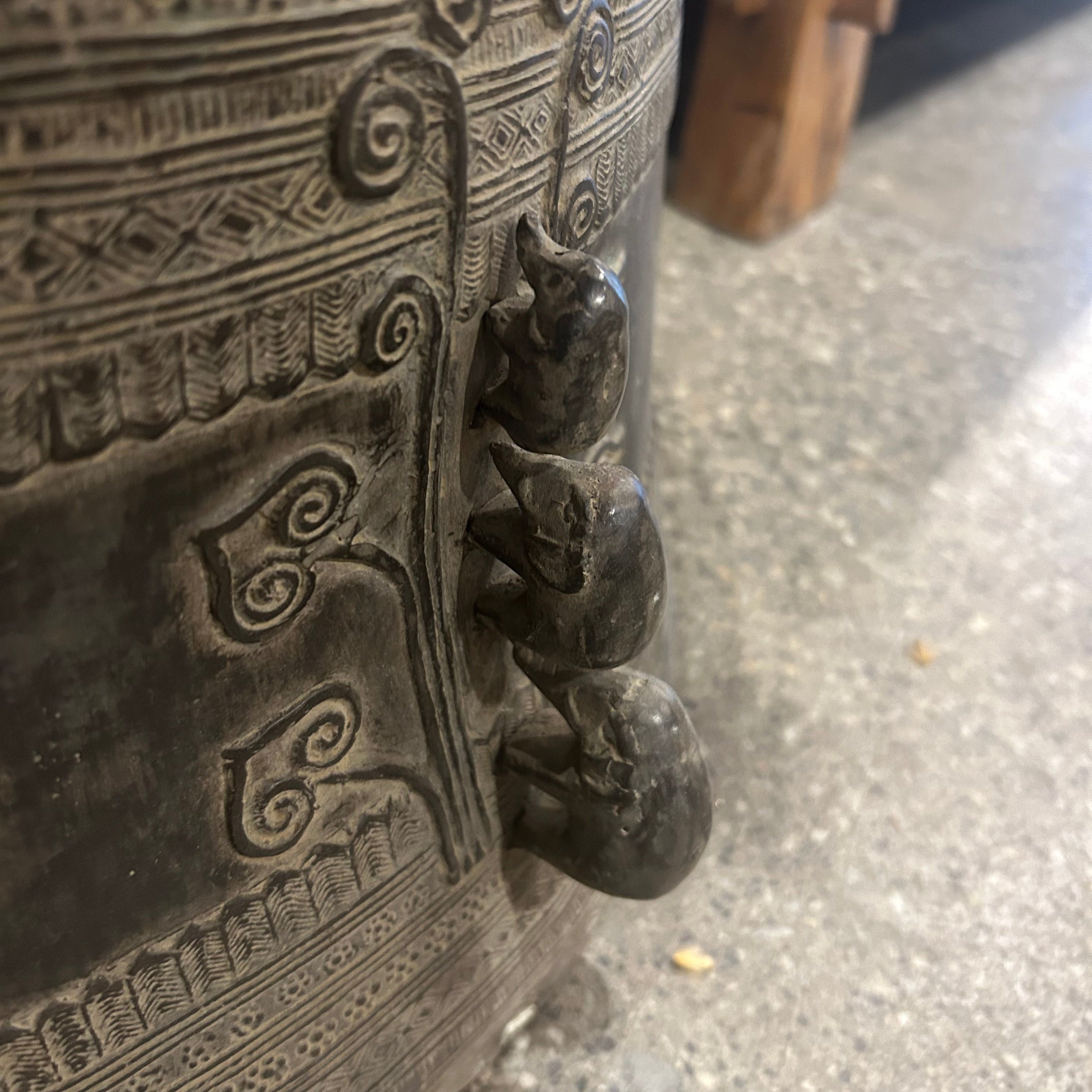 Three small stone elephants on a textured surface with a blurred background