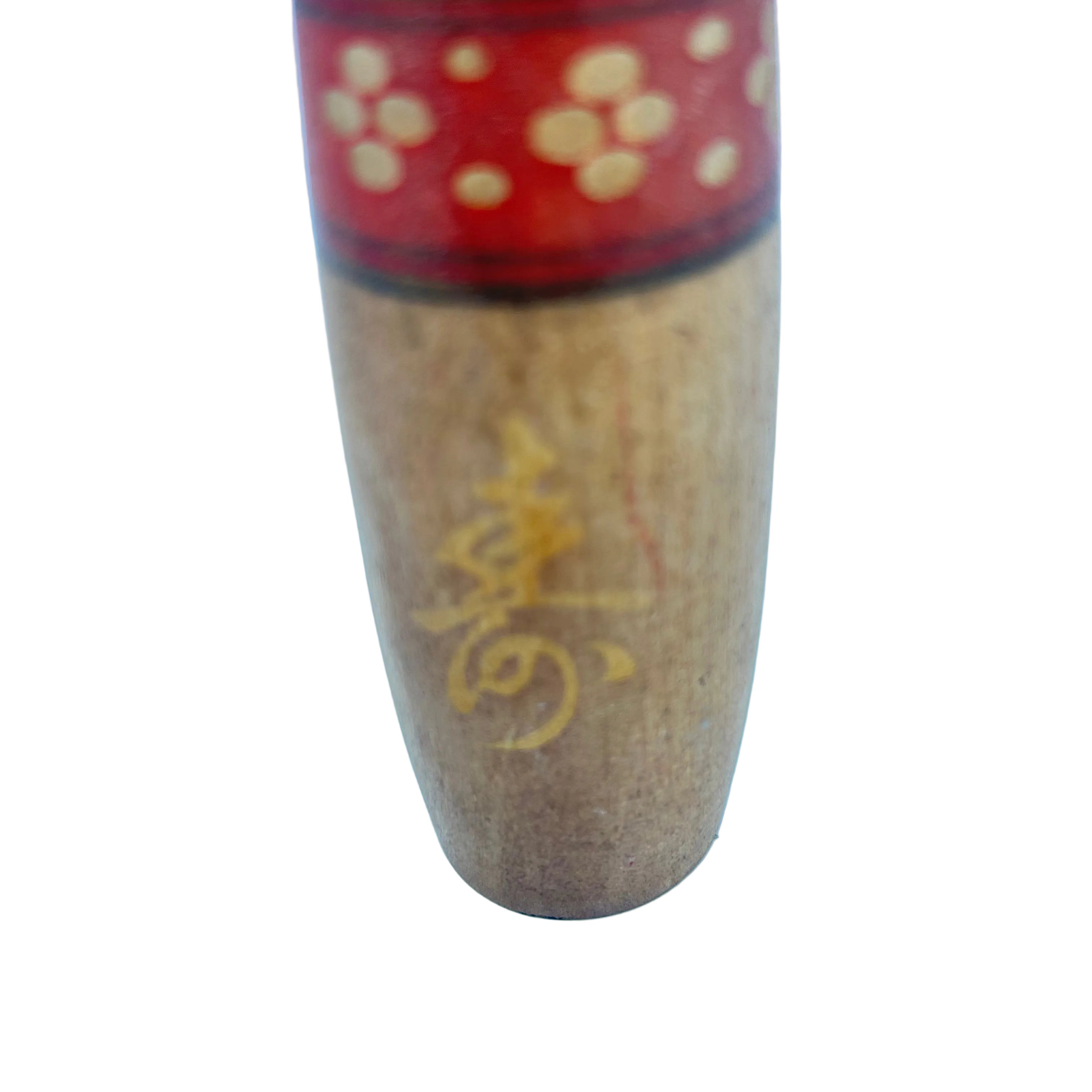 A creative kokeshi with a cute face and hair in top knot.