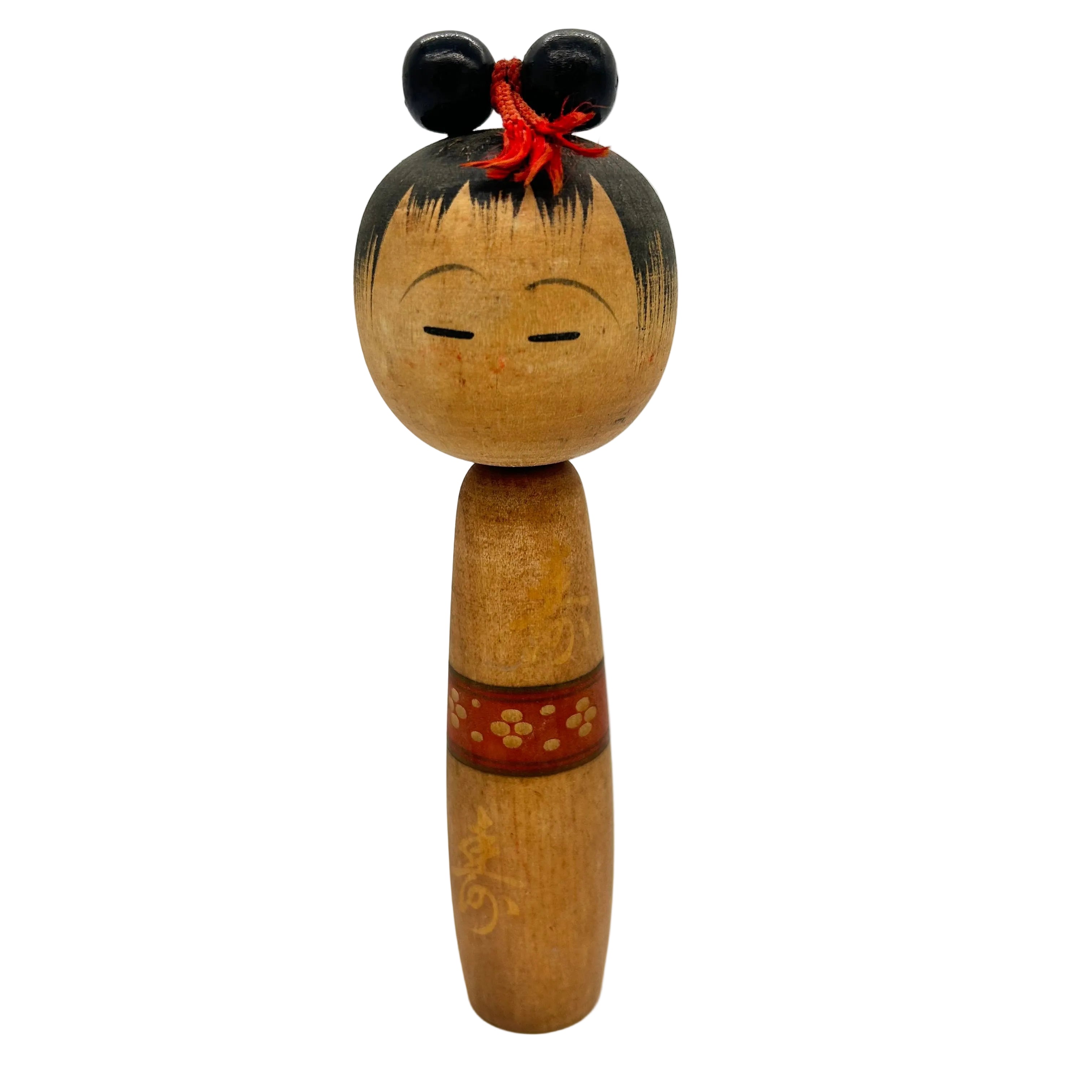 A creative kokeshi with a cute face and hair in top knot.