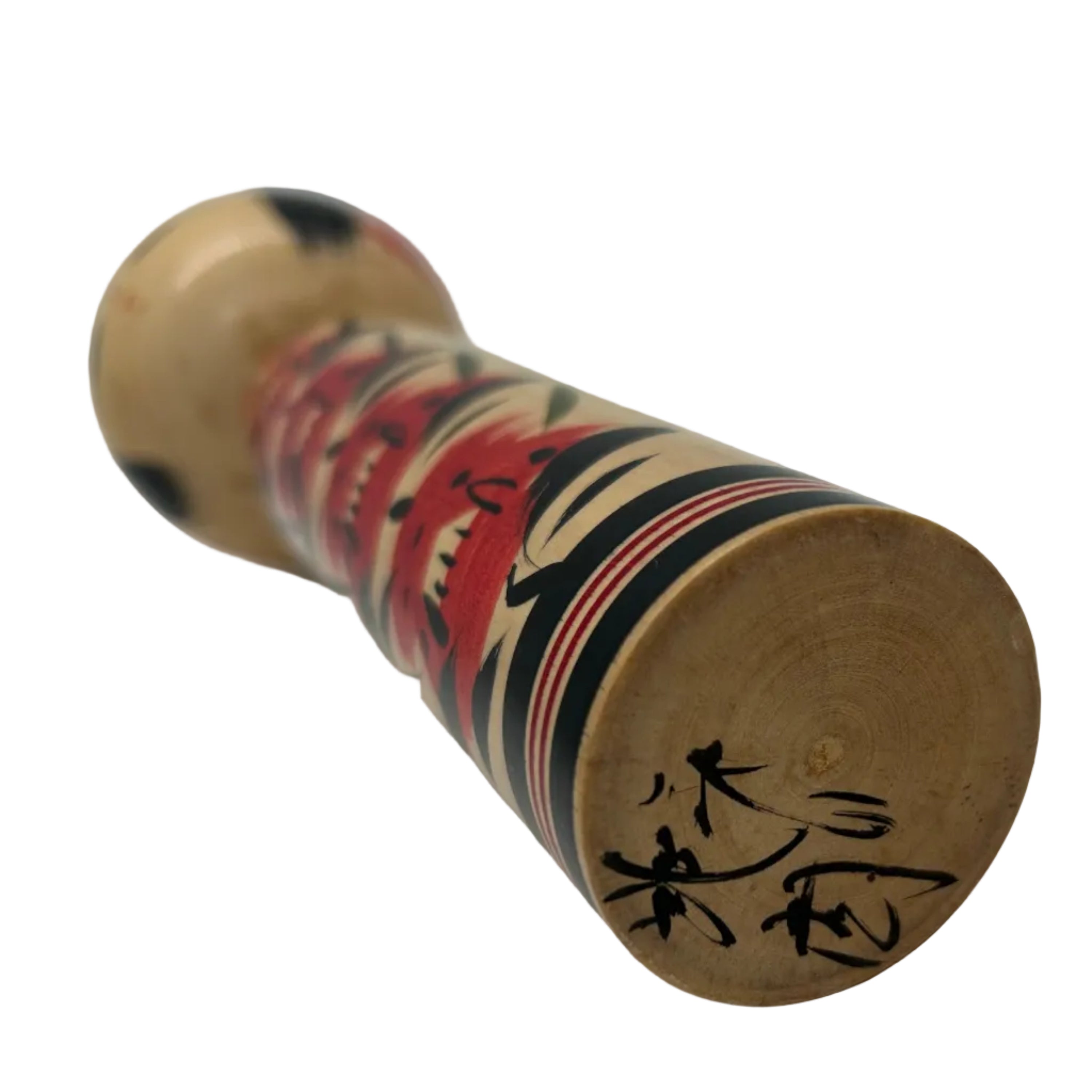 A vintage traditional Japanese Togatta kokeshi from Miyagi prefecture. She has an individual pattern on her torso. Signed on the base.