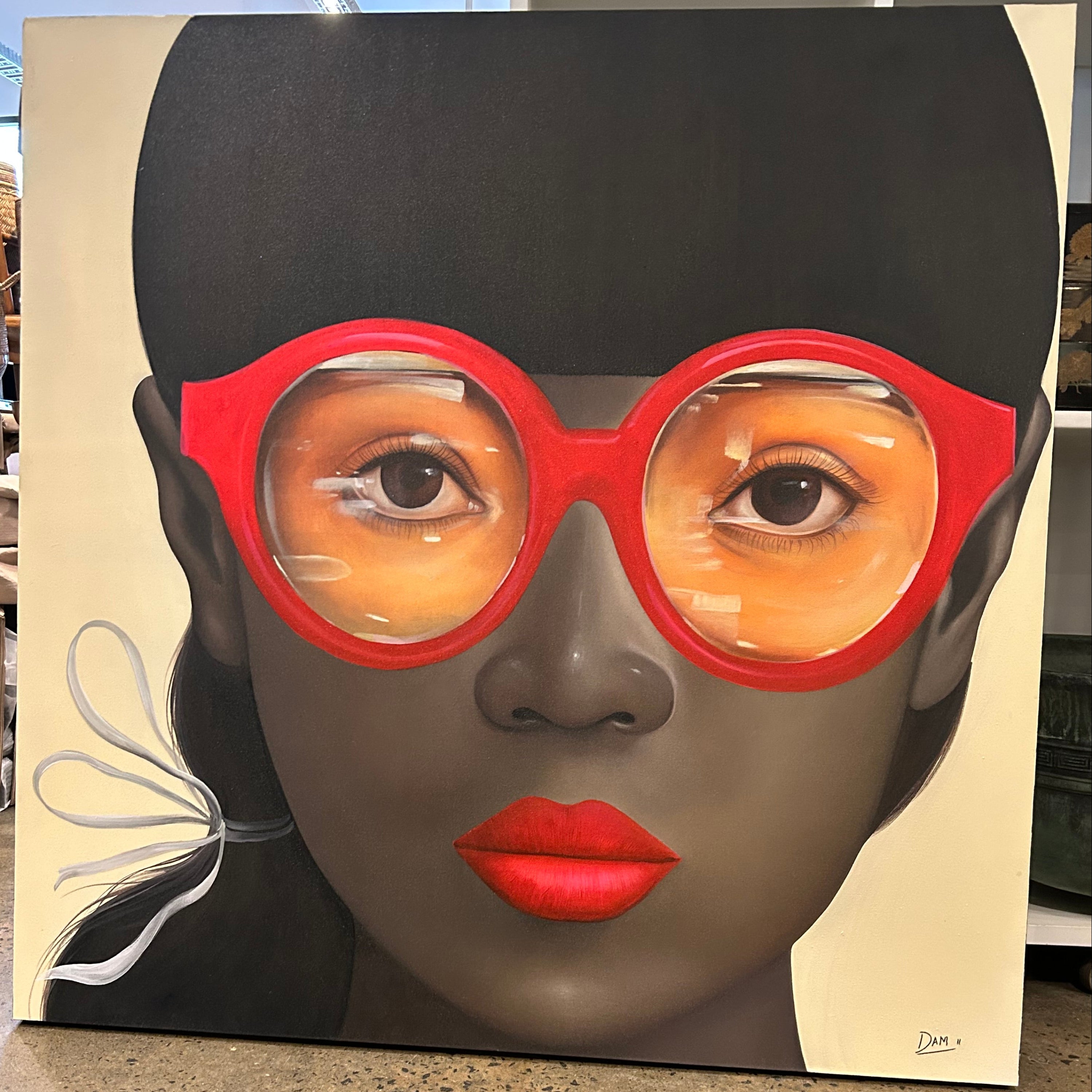 A beautiful oriental girl wearing striking red glasses