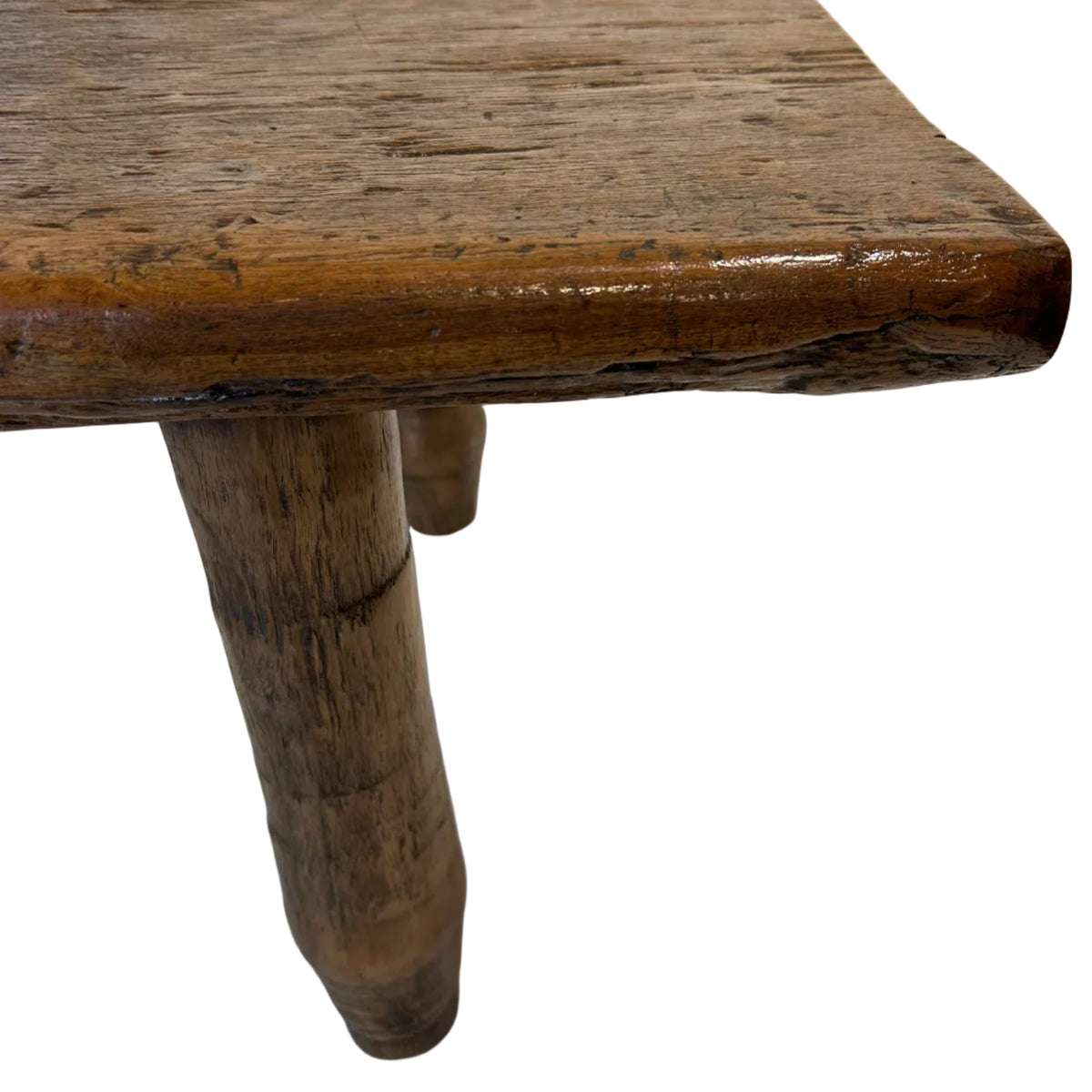 This folk art coffee table is crafted from recycled teak wood, celebrating the natural beauty and character of the timber. Its solid construction gives it a strong, grounded presence.