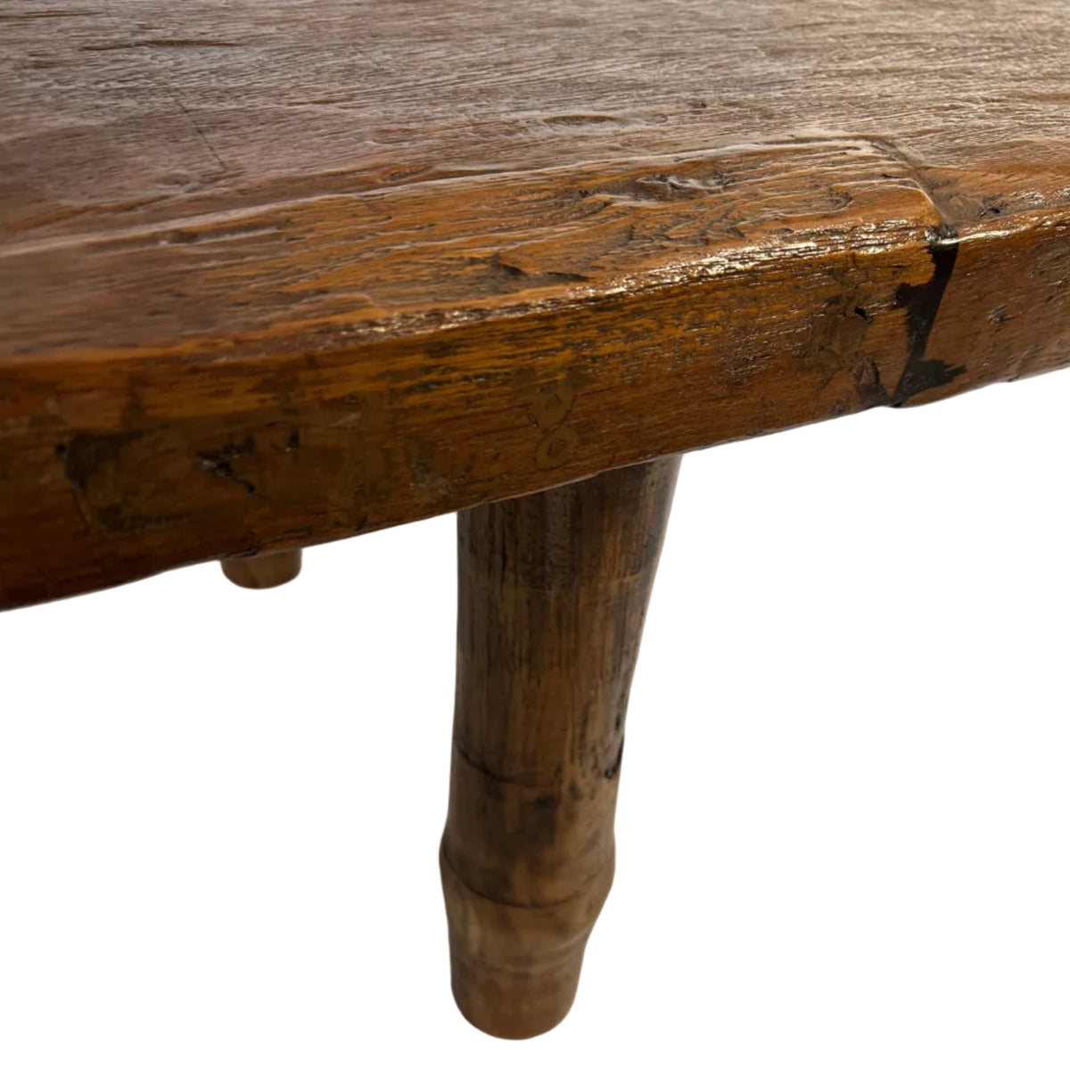 This folk art coffee table is crafted from recycled teak wood, celebrating the natural beauty and character of the timber. Its solid construction gives it a strong, grounded presence.