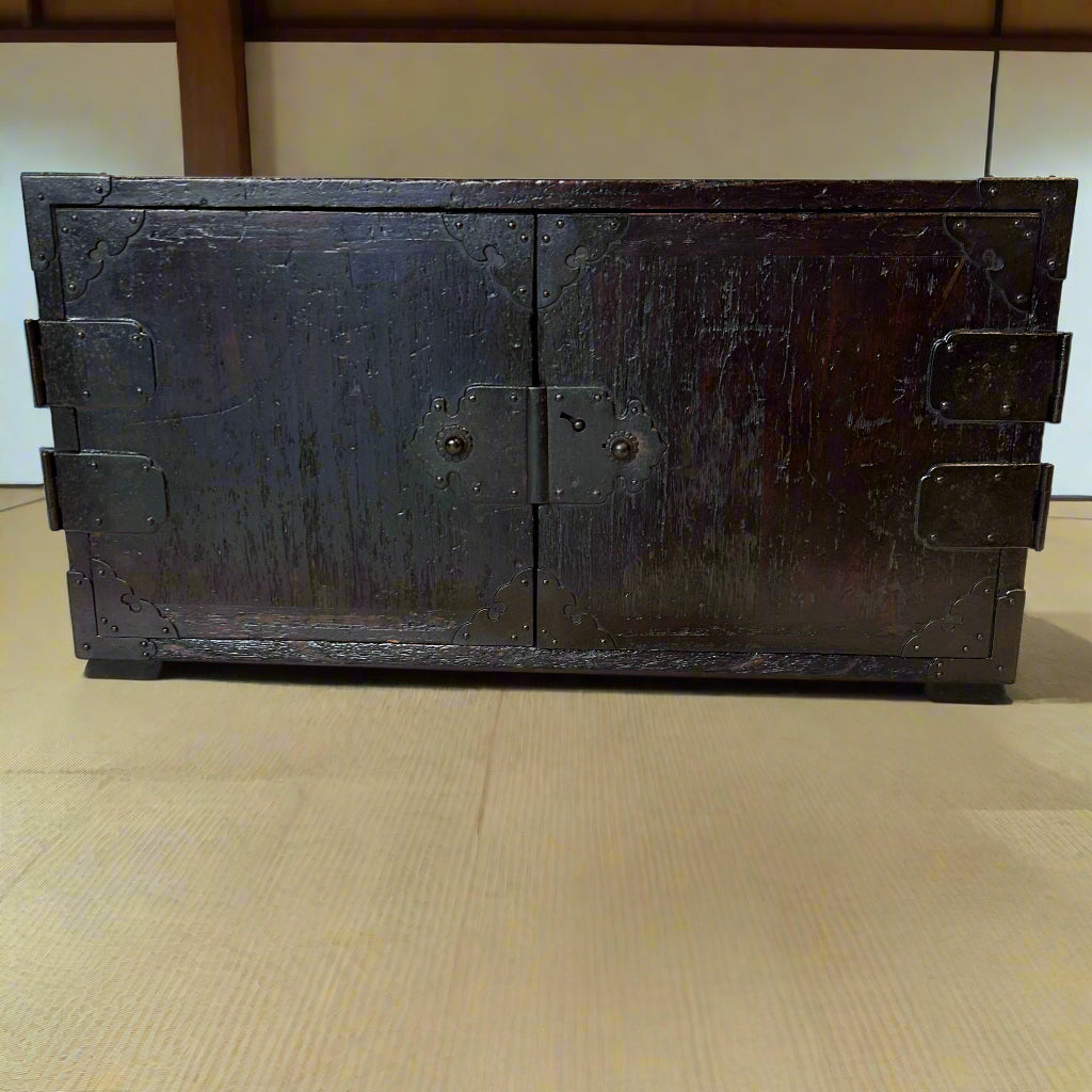 A Japanese accounts chest with double doors for security. Made from paulownia wood with iron hardware. EDO period C1800.