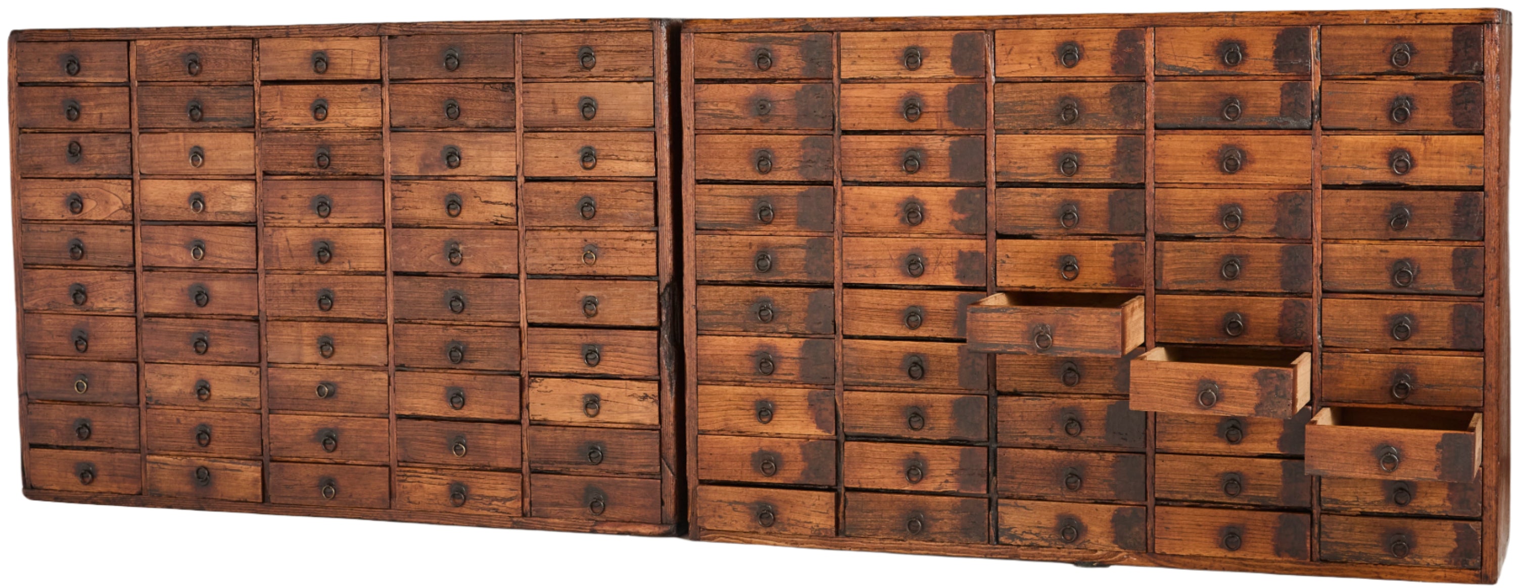 A pair of Japanese medicine chests (kasuri-dansu). Made from paulownia wood and each with 50 drawers. EDO period C1850.