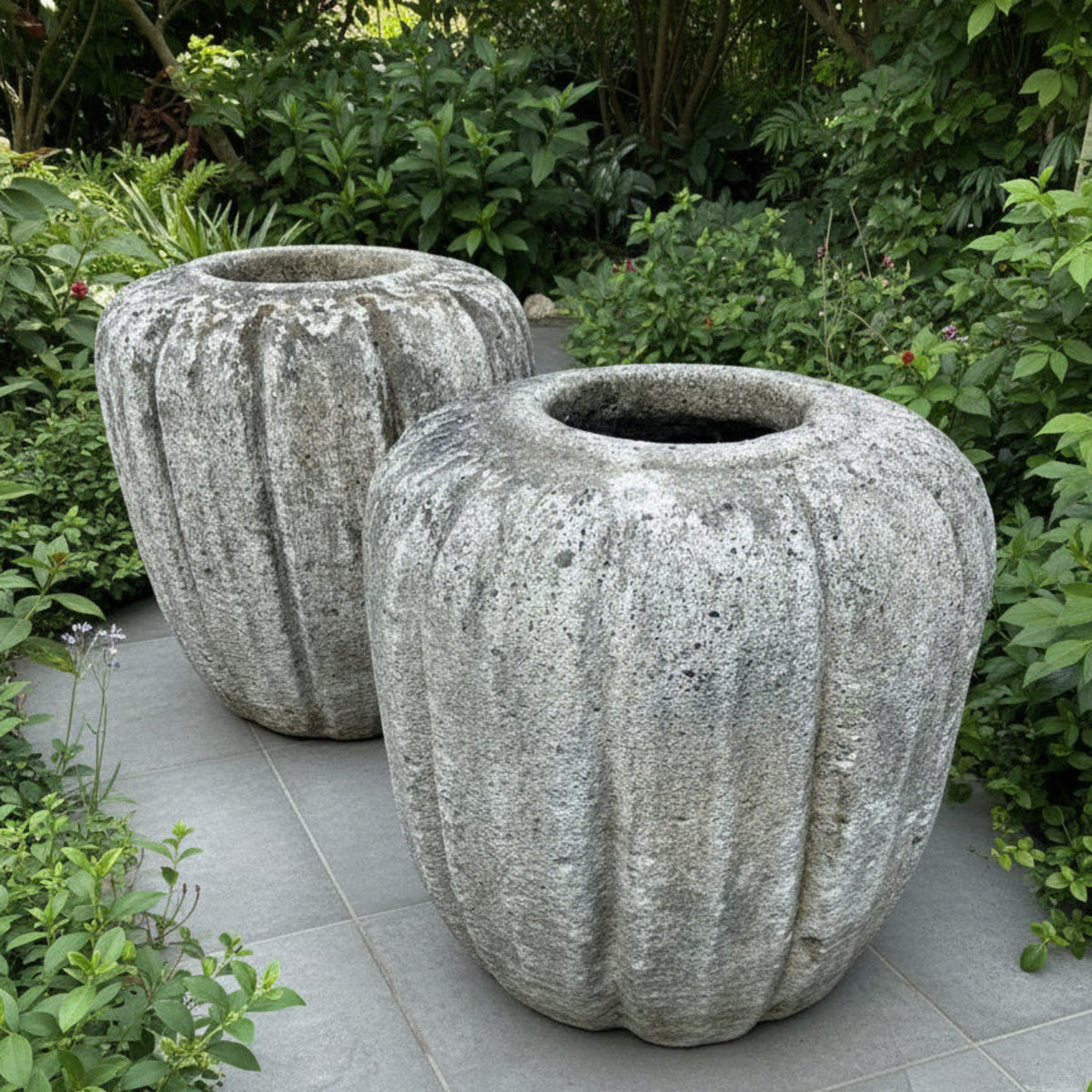Large stone garden pots in a garden