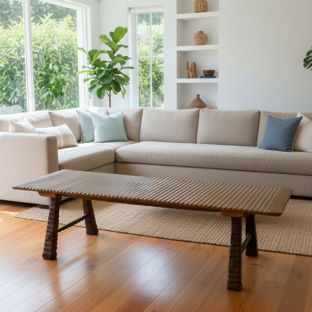 This unique and substantial coffee table is crafted from teak wood, celebrating the natural beauty and character of the wood