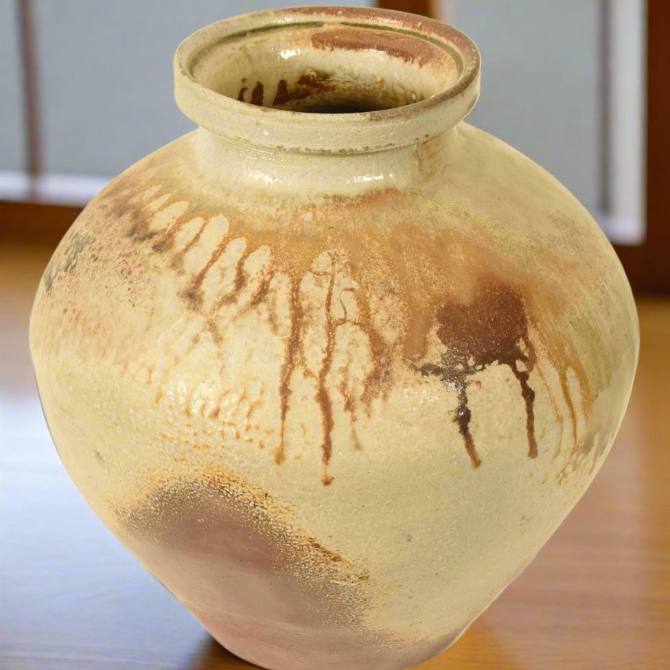 A Japanese Echizen studio pottery vase by&nbsp;Yutaka Nakamura. It has a speckled uneven terracotta coloured glaze, with a sage green and brown overglazes dripping over the top. Each&nbsp;side presents&nbsp;a different face. The lip of the vase is not uniform, giving it a wabi sabi feel and visual interest.