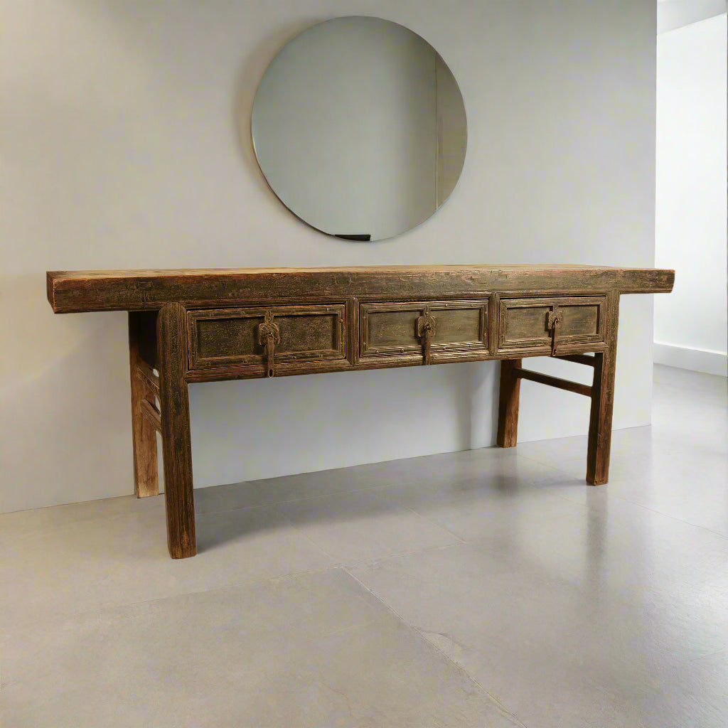 Substantial provincial Chinese Buddhist altar table, made from solid elm. The table has three drawers with iron hardware and simple carved design. The wood has a warm aged patina.

From Shanxi province, Qianlong, Qing dynasty, 18th century.