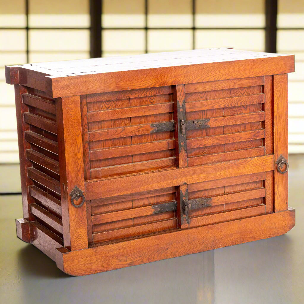 A rare lacquered Kuruma Dansu, wheeled storage chest. It has been made almost entirely from zelkova wood with paulownia drawer linings. It has top and bottom sliding doors, a shelf in the upper half and drawers in the lower half with iron hardware.
Edo period, first half of the 19th century.