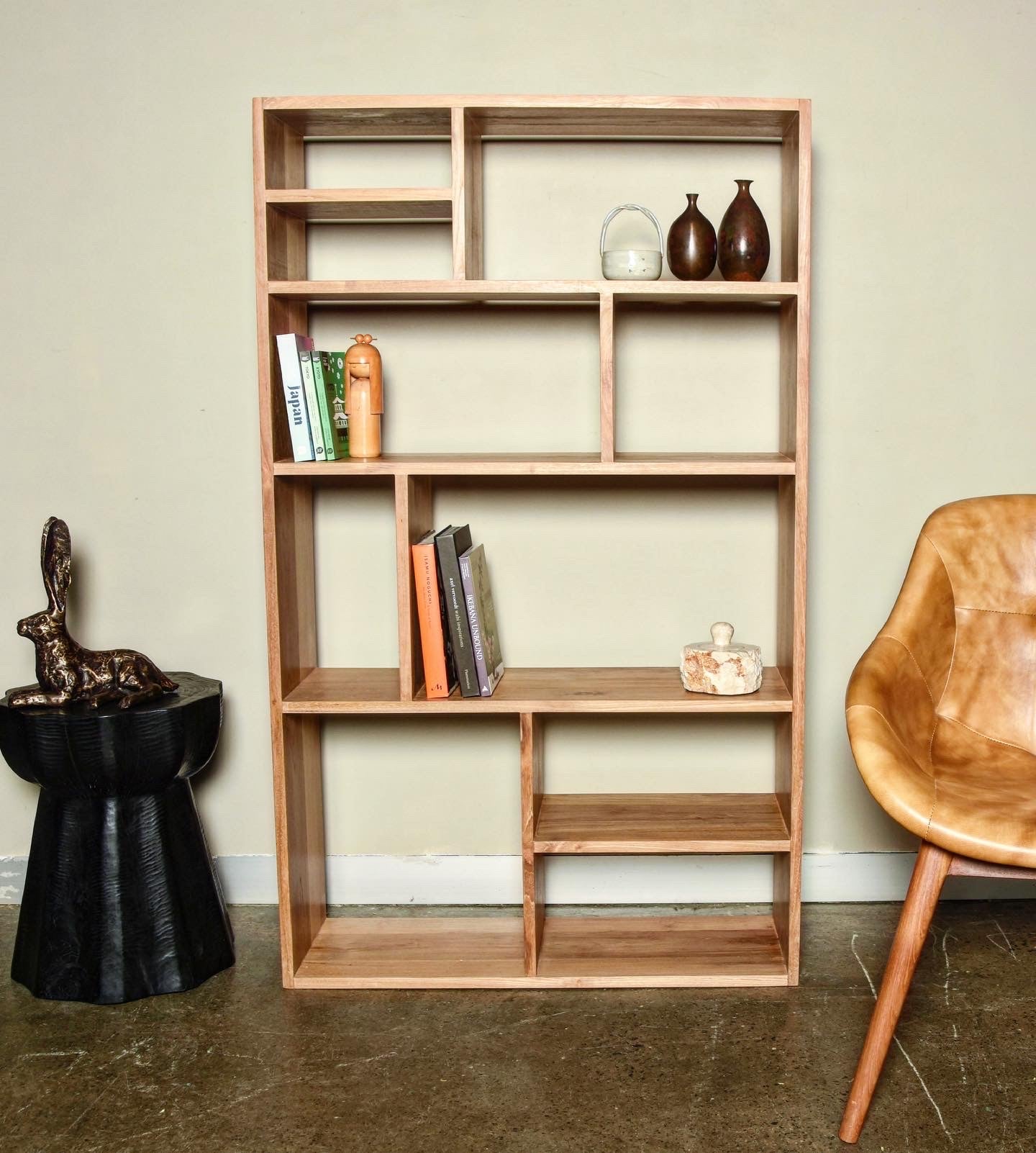 A finely crafted contemporary small bookcase made from sustainably sourced solid teak (not veneer or laminated) with a natural wax finish.