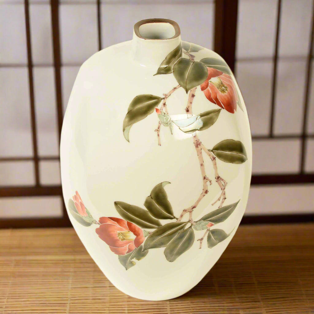 A remarkable, delicately hand painted Kutani porcelain vase with a decoration of camellia blooms, with original paulownia storage box, signed, by Yoshiaki Yamada.